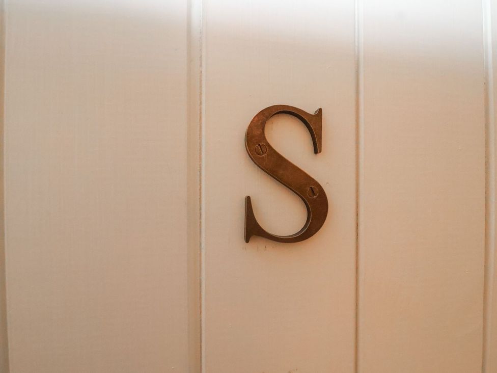 A decorative letter 'S' mounted on a wall at Swallow Studio Andoversford near Cheltenham