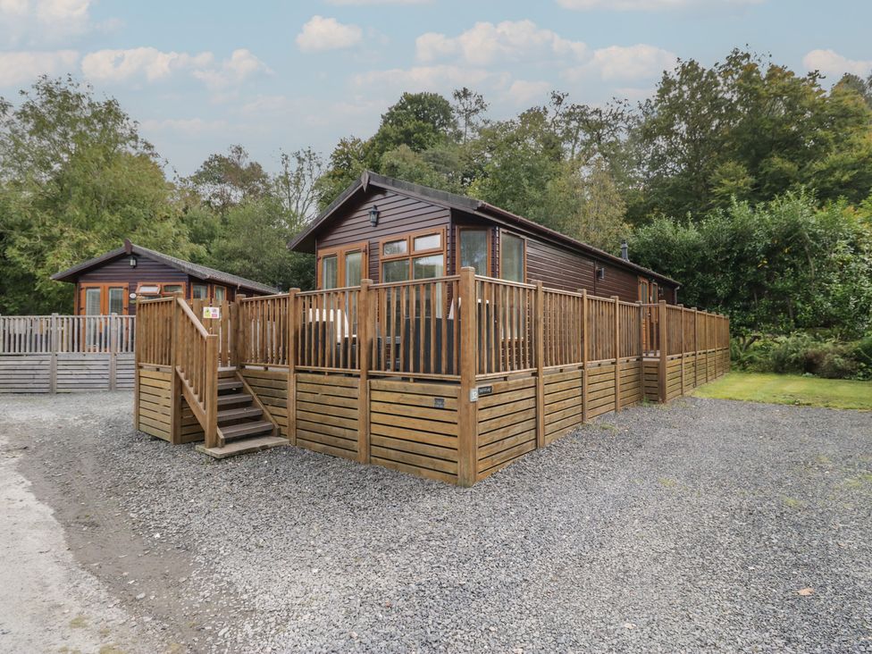 A cabin with a wooden deck and steps at 32 Grasmere in Windermere