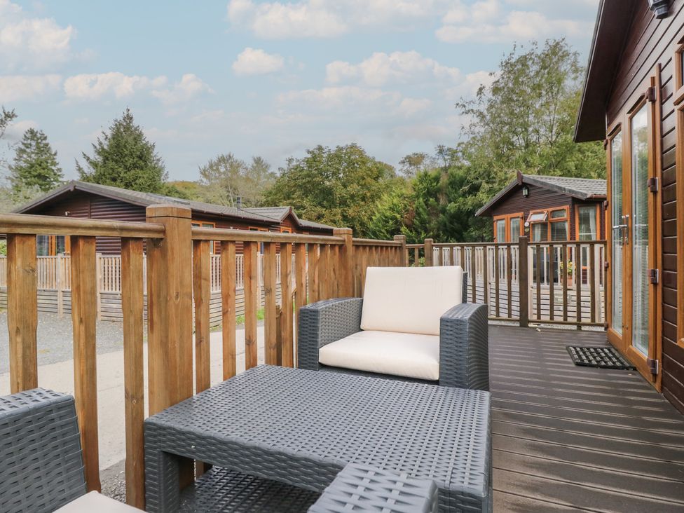 An outdoor area with deck furniture and cabins at 32 Grasmere in Windermere