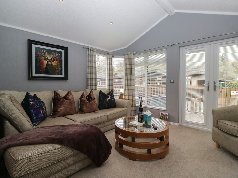 A living room with a sofa and coffee table at 32 Grasmere, White Cross Bay near Windermere