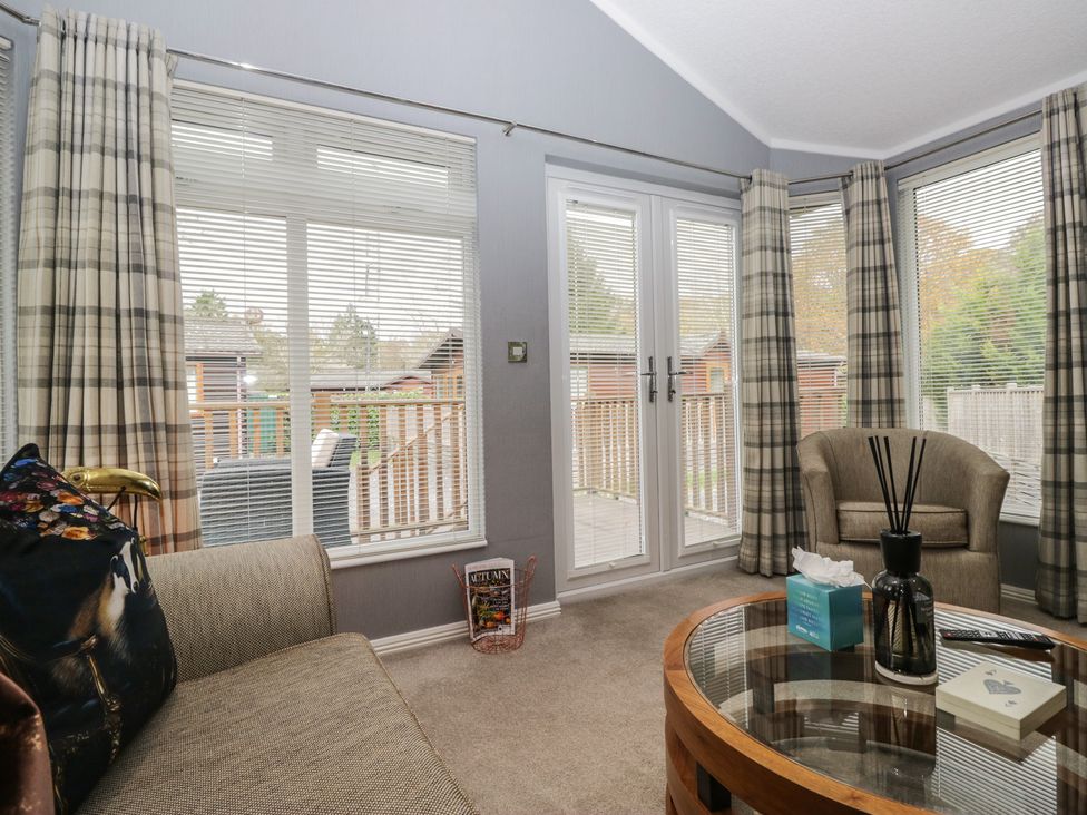 A snug with a sofa and coffee table at 32 Grasmere, White Cross Bay near Windermere