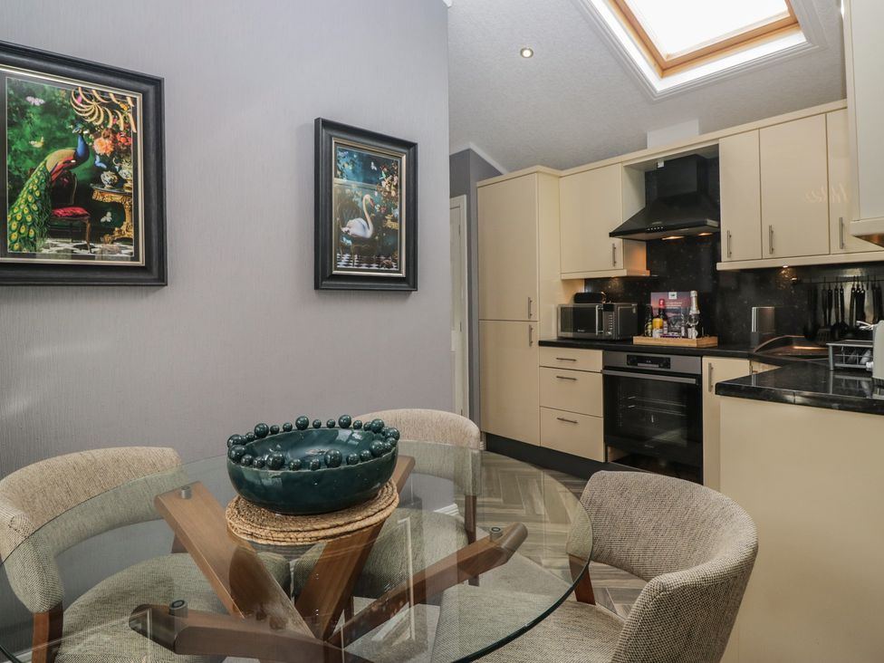 A kitchen with a dining table and chairs at 32 Grasmere, White Cross Bay near Windermere