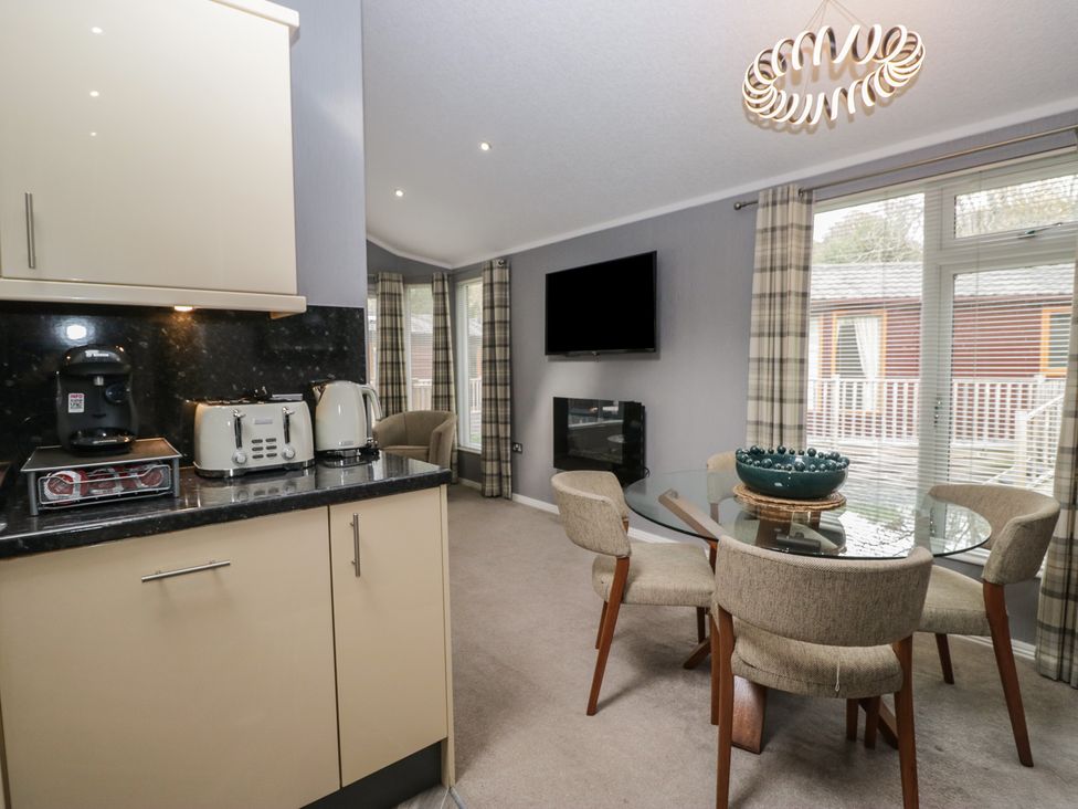 A dining area with a table and chairs at 32 Grasmere, White Cross Bay near Windermere