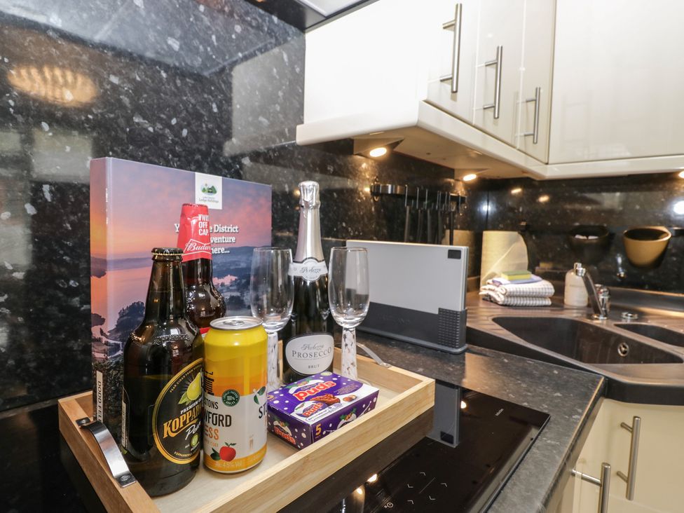 A kitchen with beverages and glasses on a tray at 32 Grasmere, White Cross Bay near Windermere