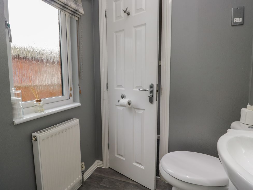 A bathroom with a window and toilet at 32 Grasmere, White Cross Bay near Windermere