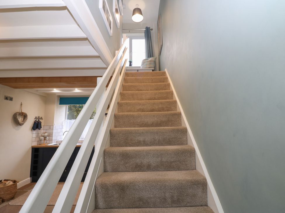 A stairway with stairs and a handrail at Tyg Cottage in Ripon