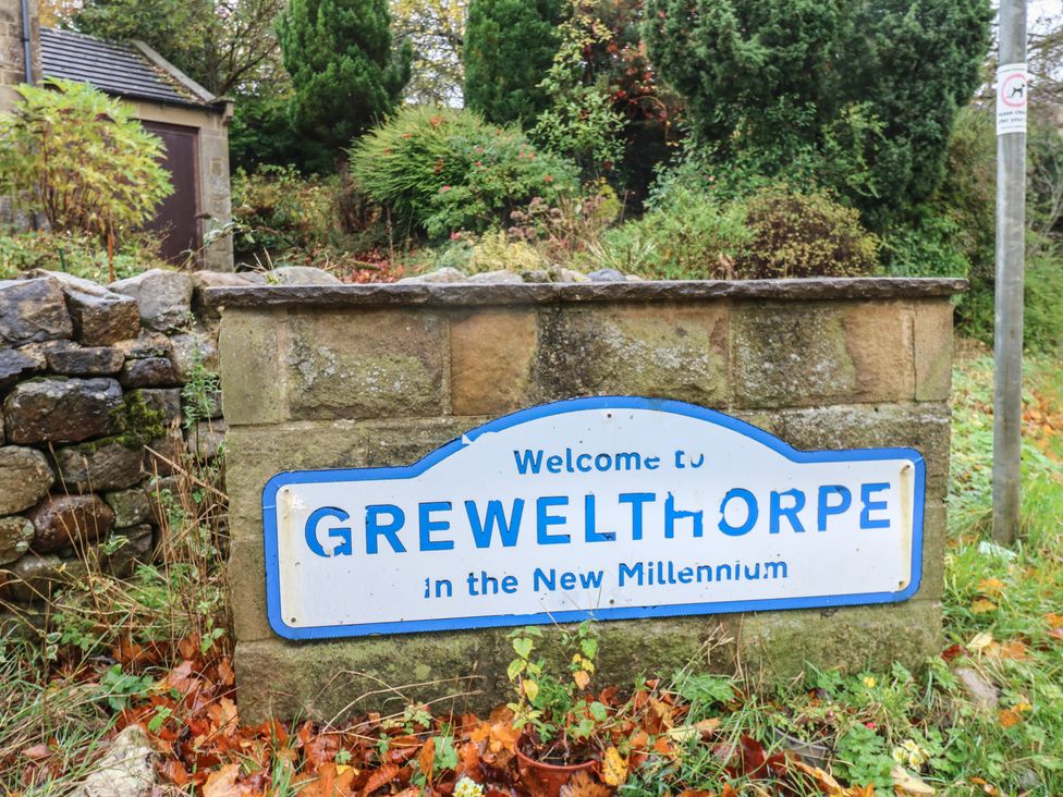 A welcome sign for Grewelthorpe in the New Millennium