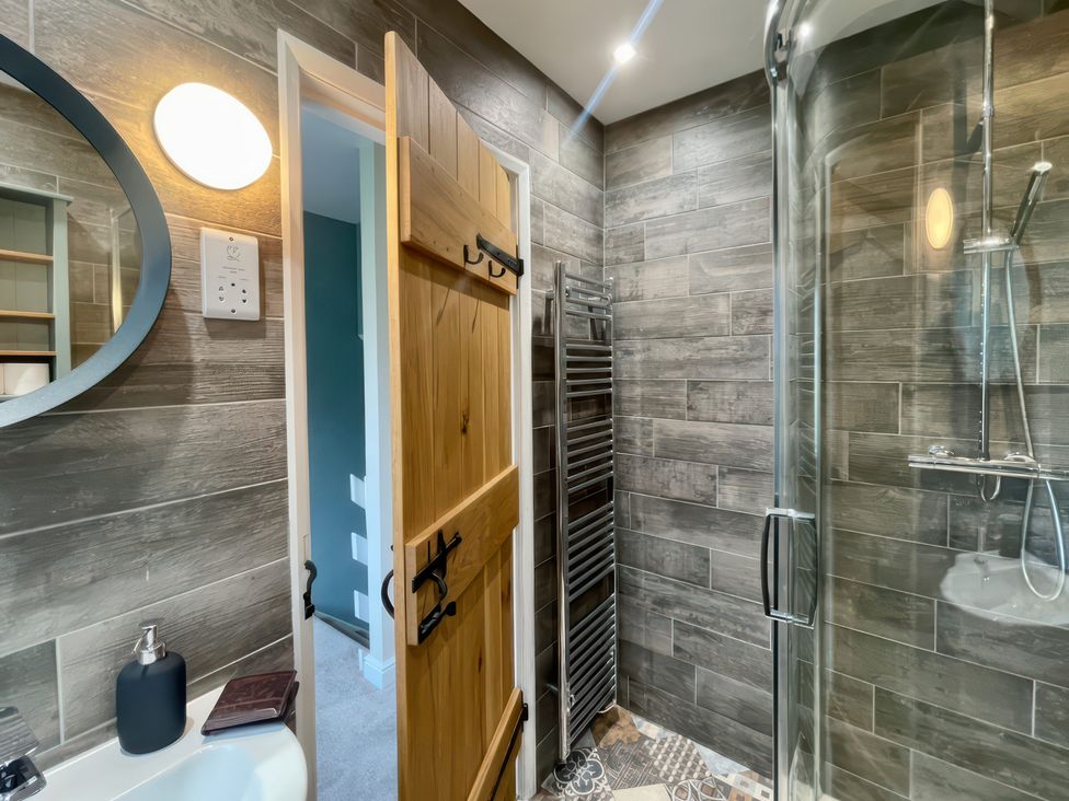 A bathroom with a shower and sink at Tyg Cottage in Masham