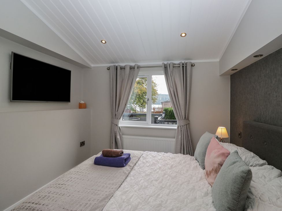 A bedroom with a bed and television at 7 Lake View in Windermere