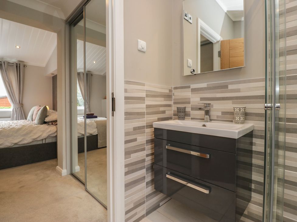 A bathroom with a sink and shower at 7 Lake View in Windermere