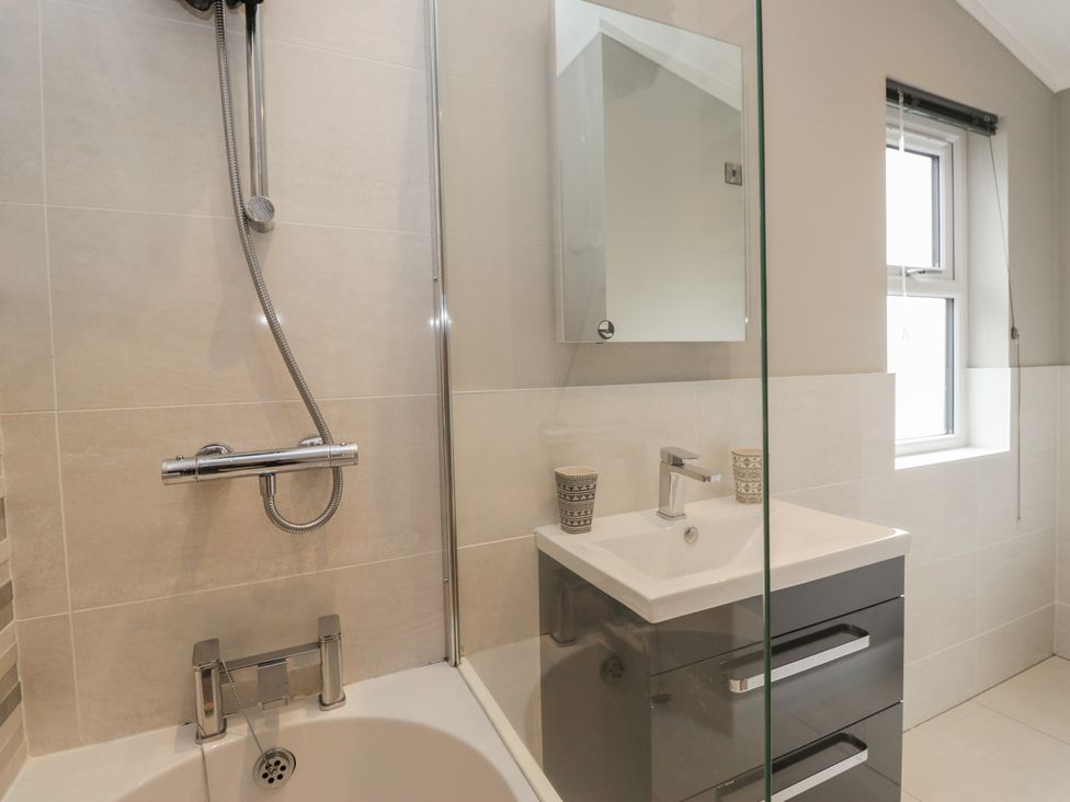 A bathroom with a shower, sink and bath at 7 Lake View Windermere