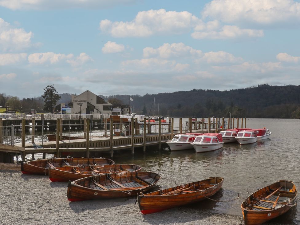 A dock with boats and a building at 7 Lake View, Windermere