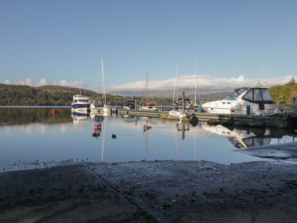 A marina with boats and calm water at 7 Lake View, Windermere