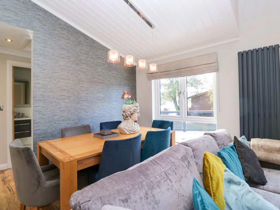 A dining room with a table and chairs at 7 Lake View, White Cross Bay near Windermere