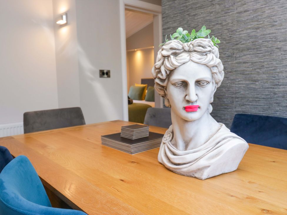 A dining room with a bust on the table at 7 Lake View, Lake View 7, White Cross Bay near Windermere