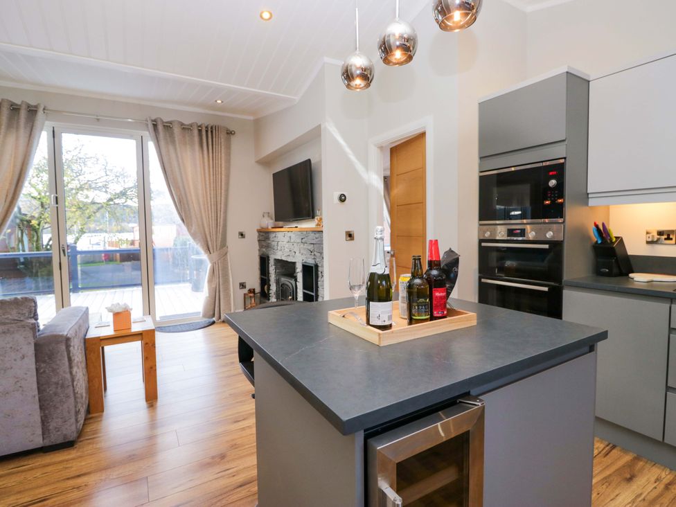 A kitchen with a gray island and wine bottles at 7 Lake View, Lake View 7, White Cross Bay near Windermere