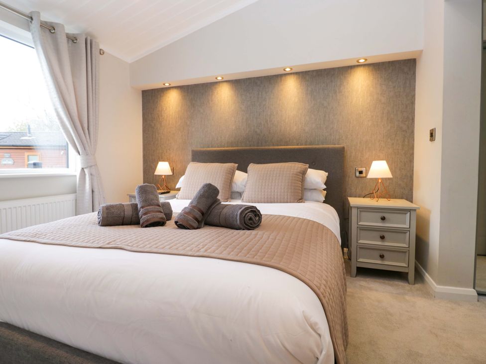 A bedroom with a bed and nightstand at 7 Lake View, Lake View 7, White Cross Bay near Windermere