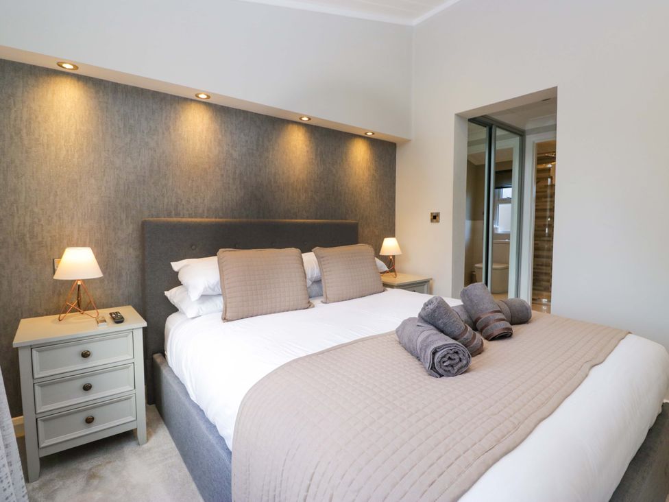 A bedroom with a bed and bedside table at 7 Lake View, Lake View 7, White Cross Bay near Windermere
