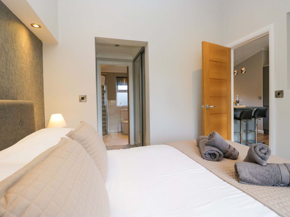 A bedroom with a bed and towels at 7 Lake View, Lake View 7, White Cross Bay near Windermere