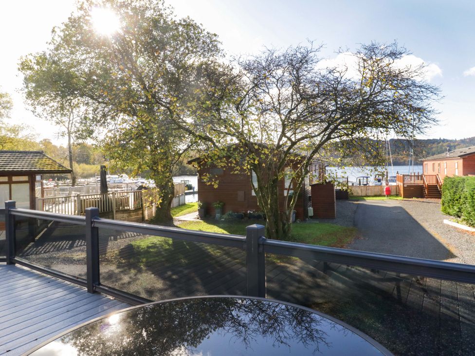 An outdoor area with a tree and cabins at 7 Lake View, Lake View 7, White Cross Bay near Windermere