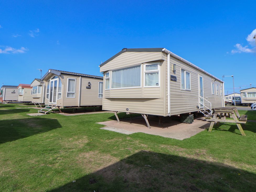 A static caravan with steps and outdoor seating at A5 Static Caravan in Rhyl