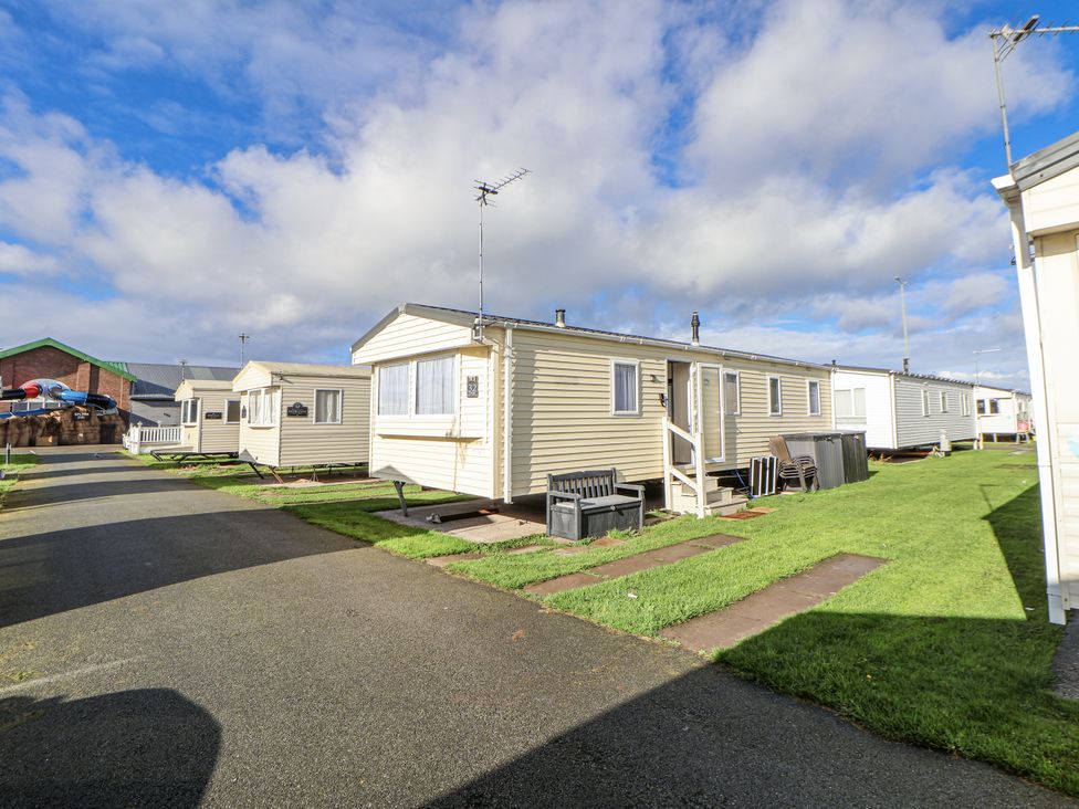 A caravan park with multiple caravans and a pathway at Chappie's Caravan - Rhyl 8, Rhyl