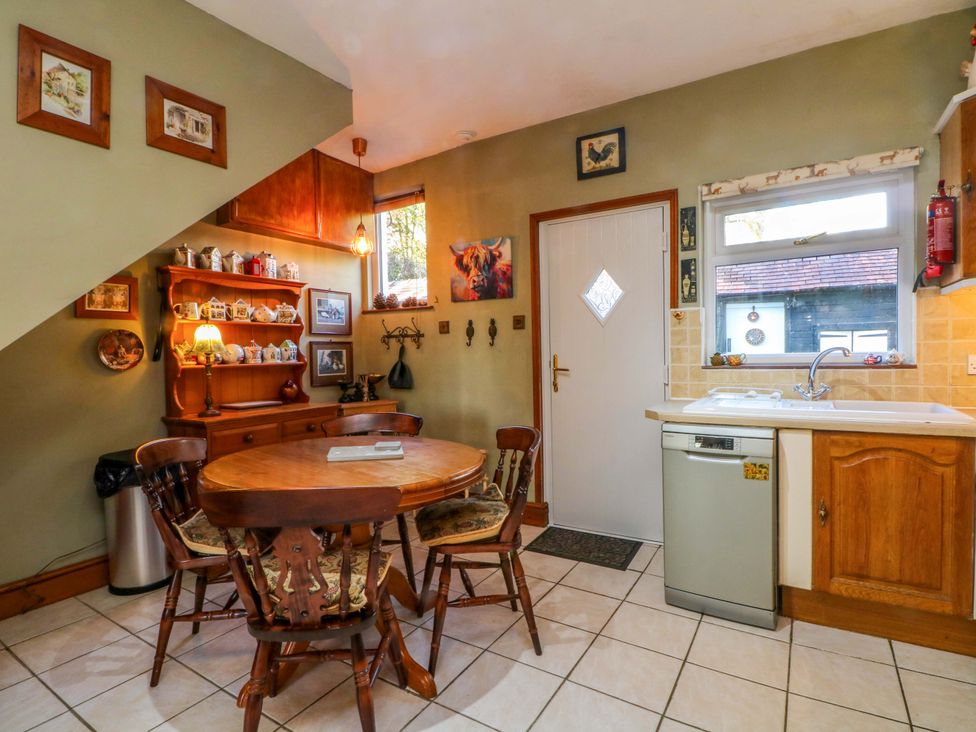 A kitchen with table and chairs at Pineapple Cottage