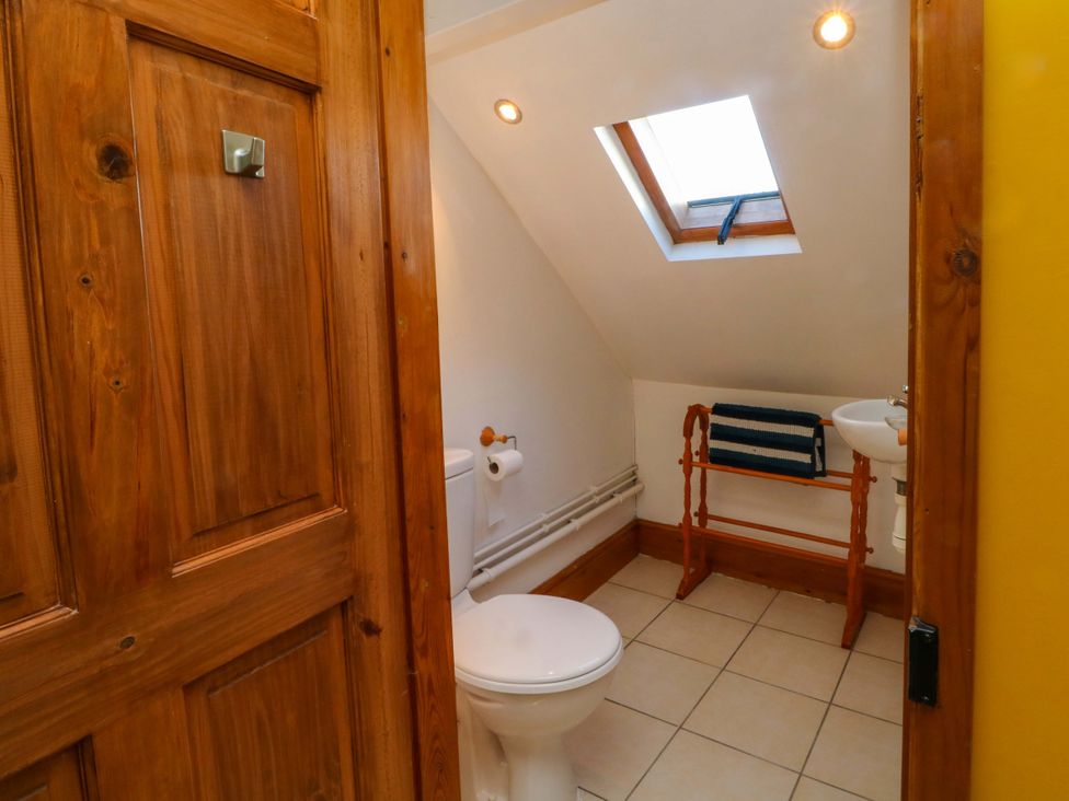 A bathroom with a toilet and sink at Pineapple Cottage 