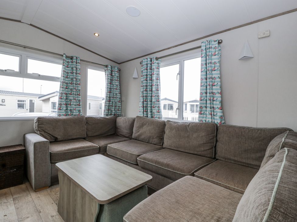 A living room with a sofa and coffee table at Caravan - 2 Bayside Watchet