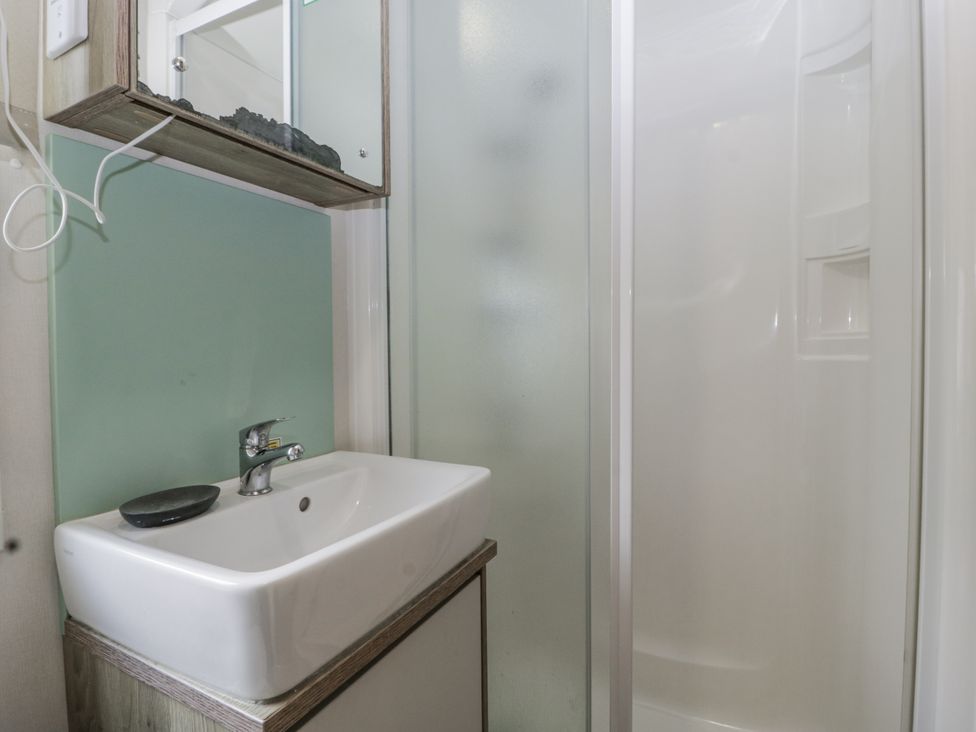 A bathroom with a sink and shower at Caravan - 2 Bayside Watchet