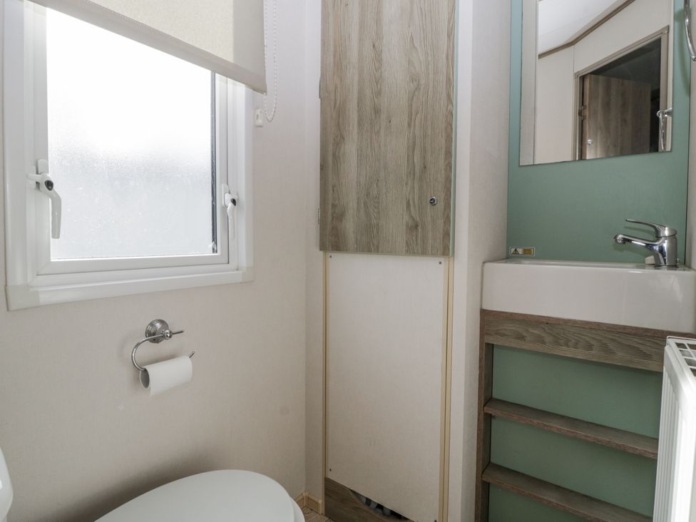 A bathroom with a toilet and sink at Caravan - 2 Bayside in Watchet