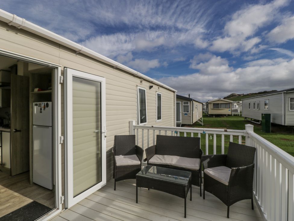 A deck with chairs and a table at Caravan - 2 Bayside Watchet