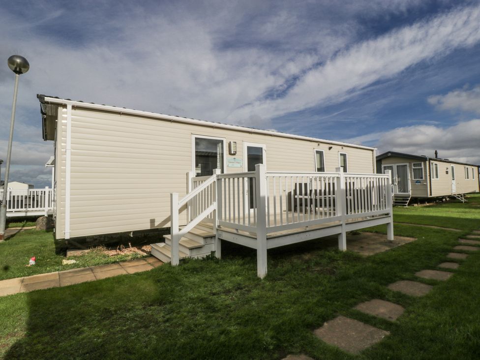 A caravan with a deck and pathway at Caravan - 2 Bayside Watchet