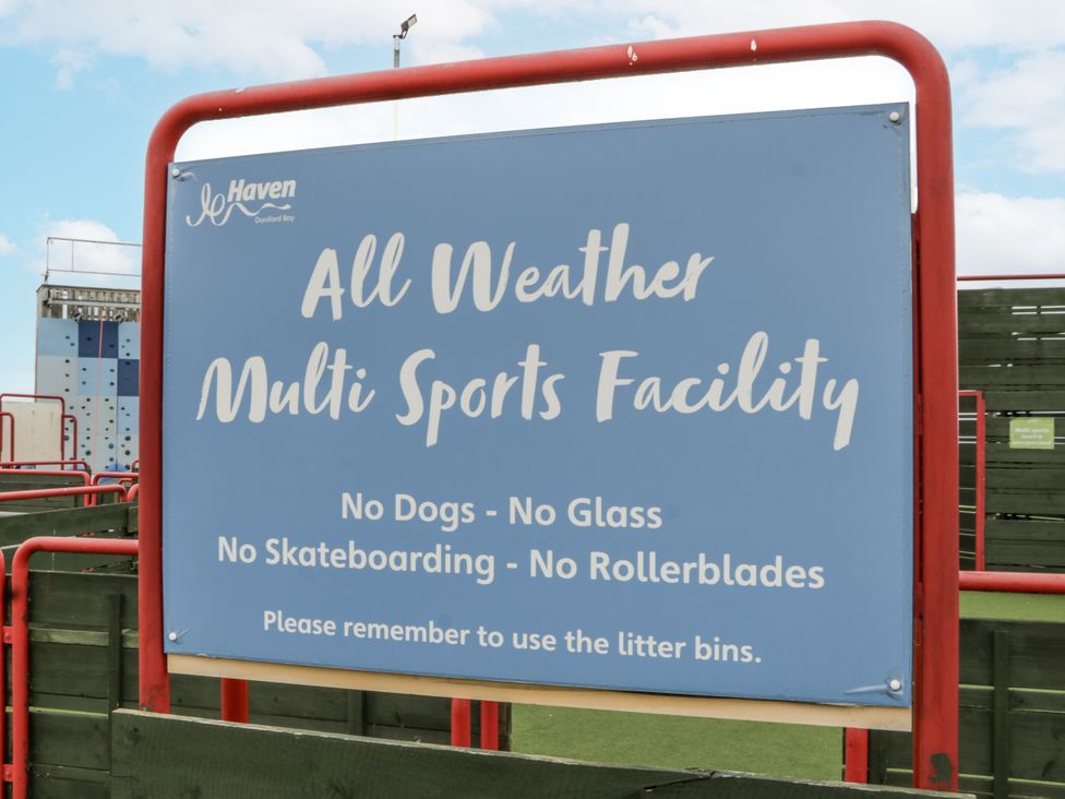 A sign for an all weather multi sports facility at Haven at Dunster Bay