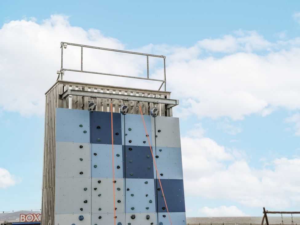 An outdoor climbing wall structure with safety ropes at Caravan - 2 Bayside Watchet