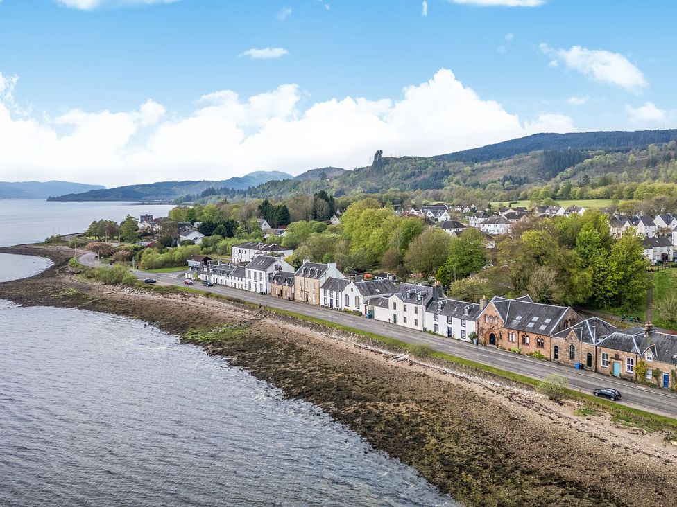 A view of buildings along the shore at Newton Hall in Inveraray