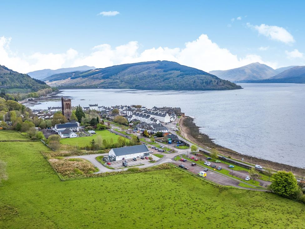 An aerial view of a coastal town with water and mountains at Newton Hall in Inveraray