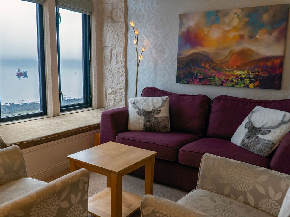 A living room with a couch and coffee table at Newton Hall in Inveraray
