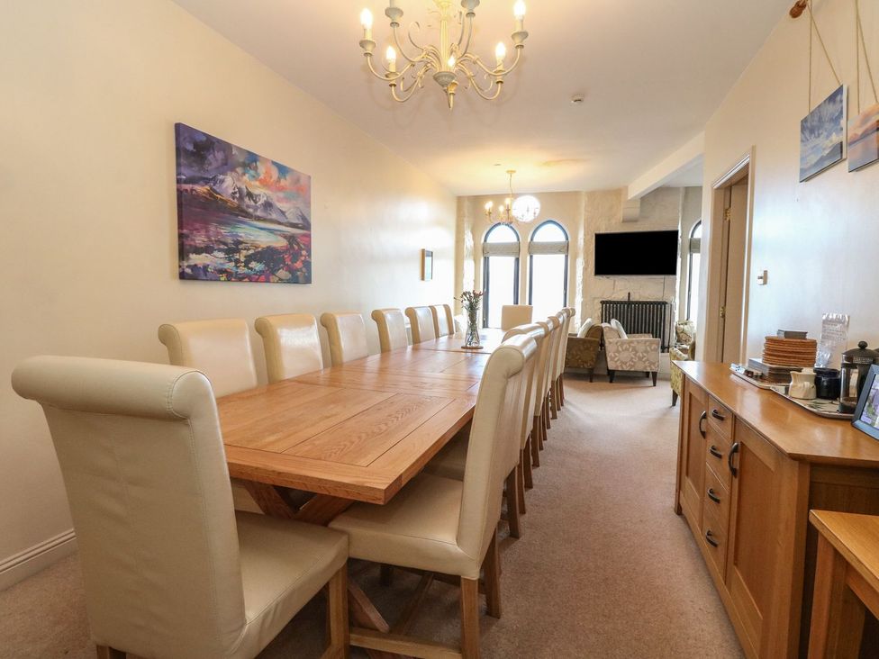 A dining room with a long table and chairs at Newton Hall in Inveraray