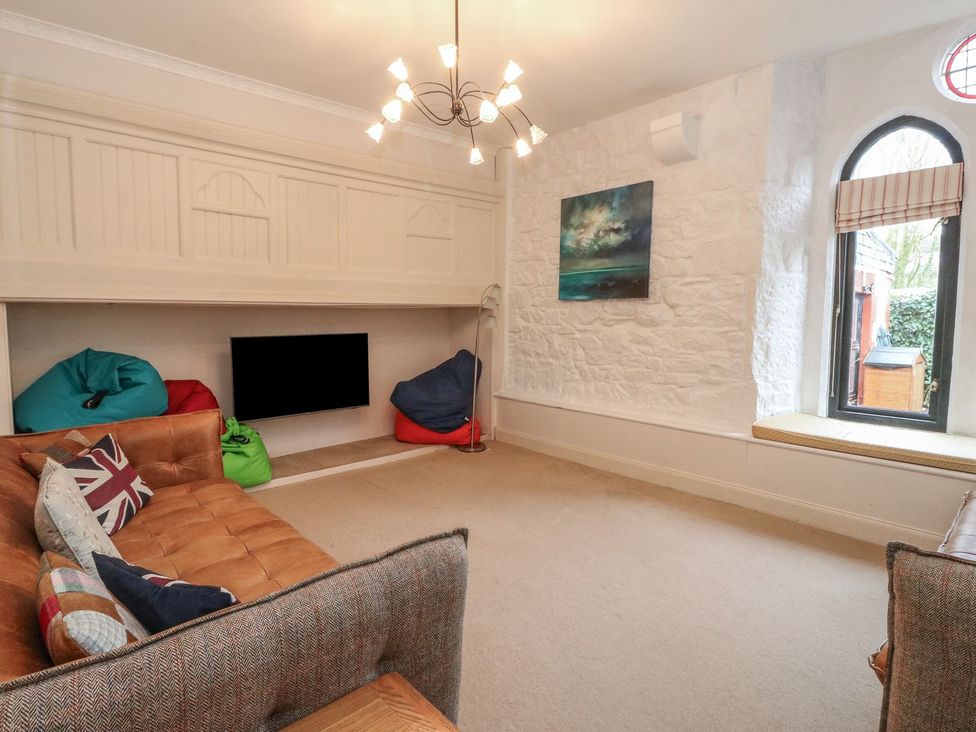 A living room with a sofa and bean bags at Newton Hall in Inveraray