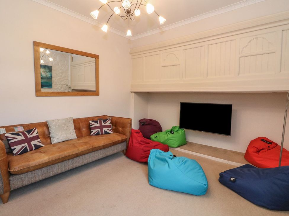 A living room with a sofa and bean bags at Newton Hall in Inveraray