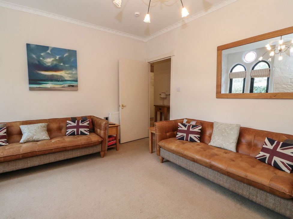 A living room with sofas and a painting at Newton Hall in Inveraray