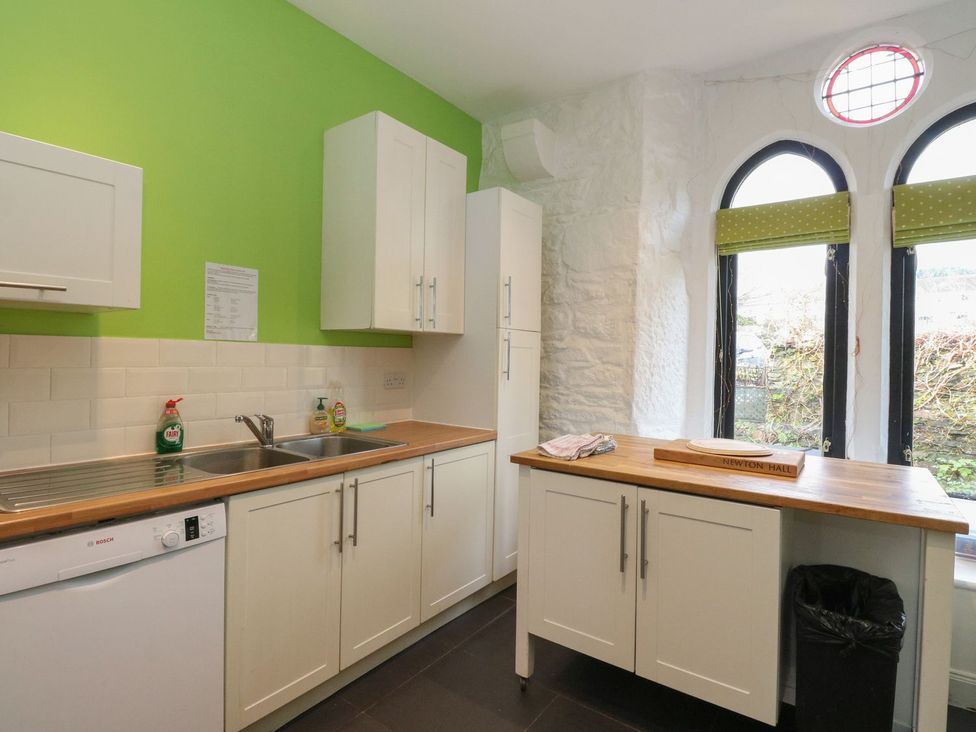 A kitchen with cabinets and a sink at Newton Hall in Inveraray