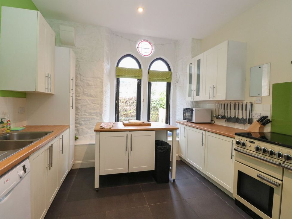 A kitchen with cabinets and a sink at Newton Hall in Inveraray