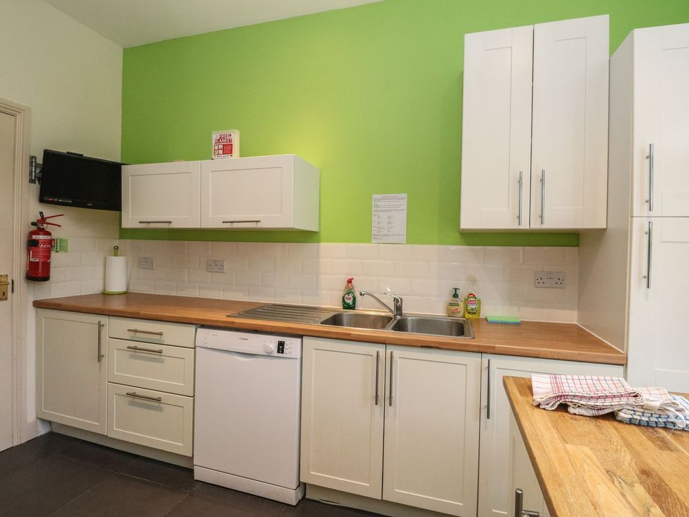 A kitchen with cabinets and a sink at Newton Hall in Inveraray