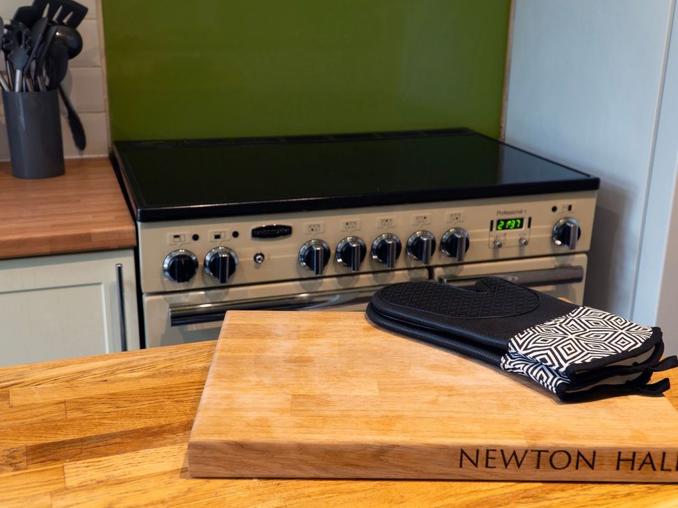 A kitchen with an oven and cutting board at Newton Hall in Inveraray