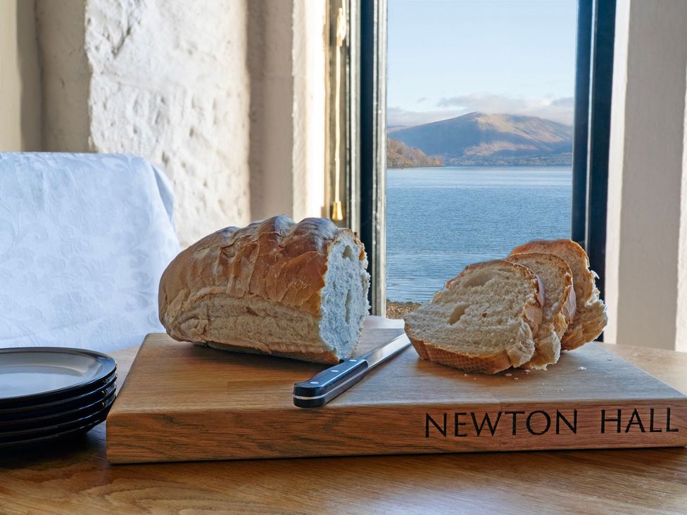 A cutting board with bread and knife at Newton Hall in Inveraray