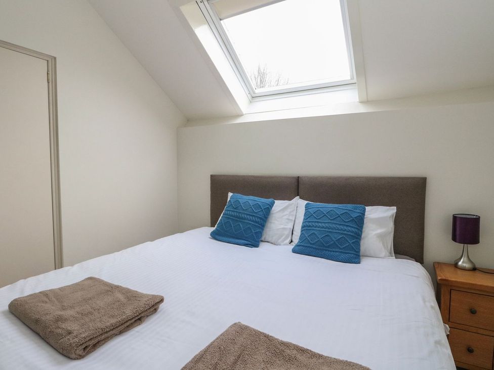 A bedroom with a bed and pillows at Newton Hall in Inveraray