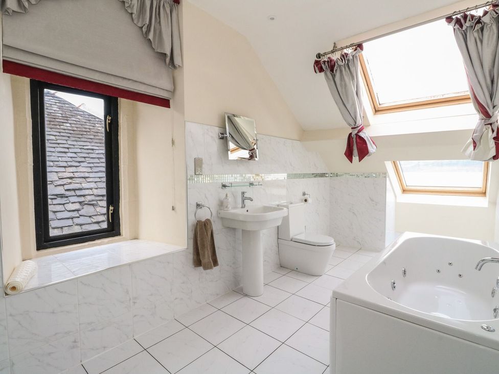 A bathroom with a sink, toilet and bathtub at Newton Hall in Inveraray