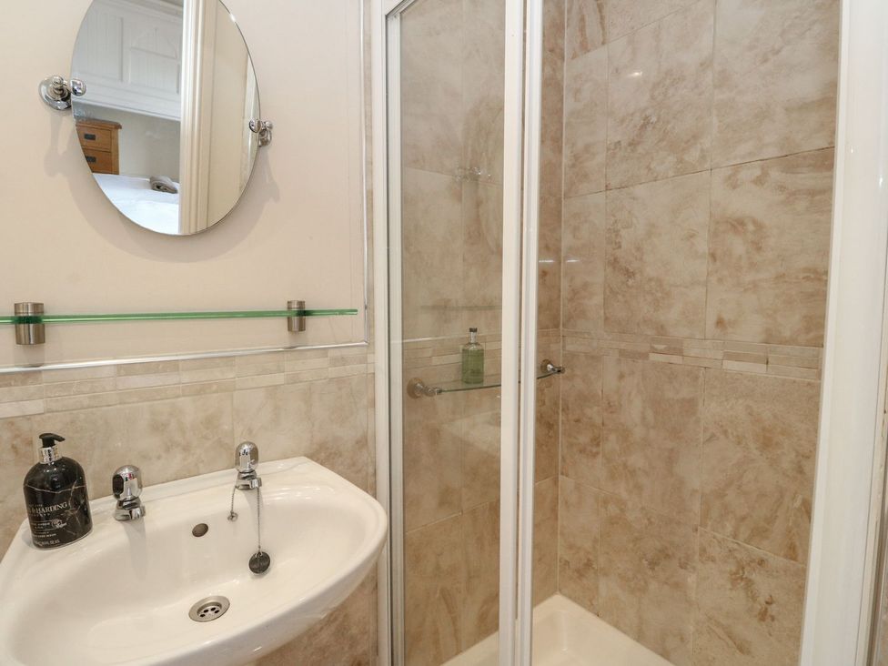 A bathroom with a sink and shower at Newton Hall in Inveraray